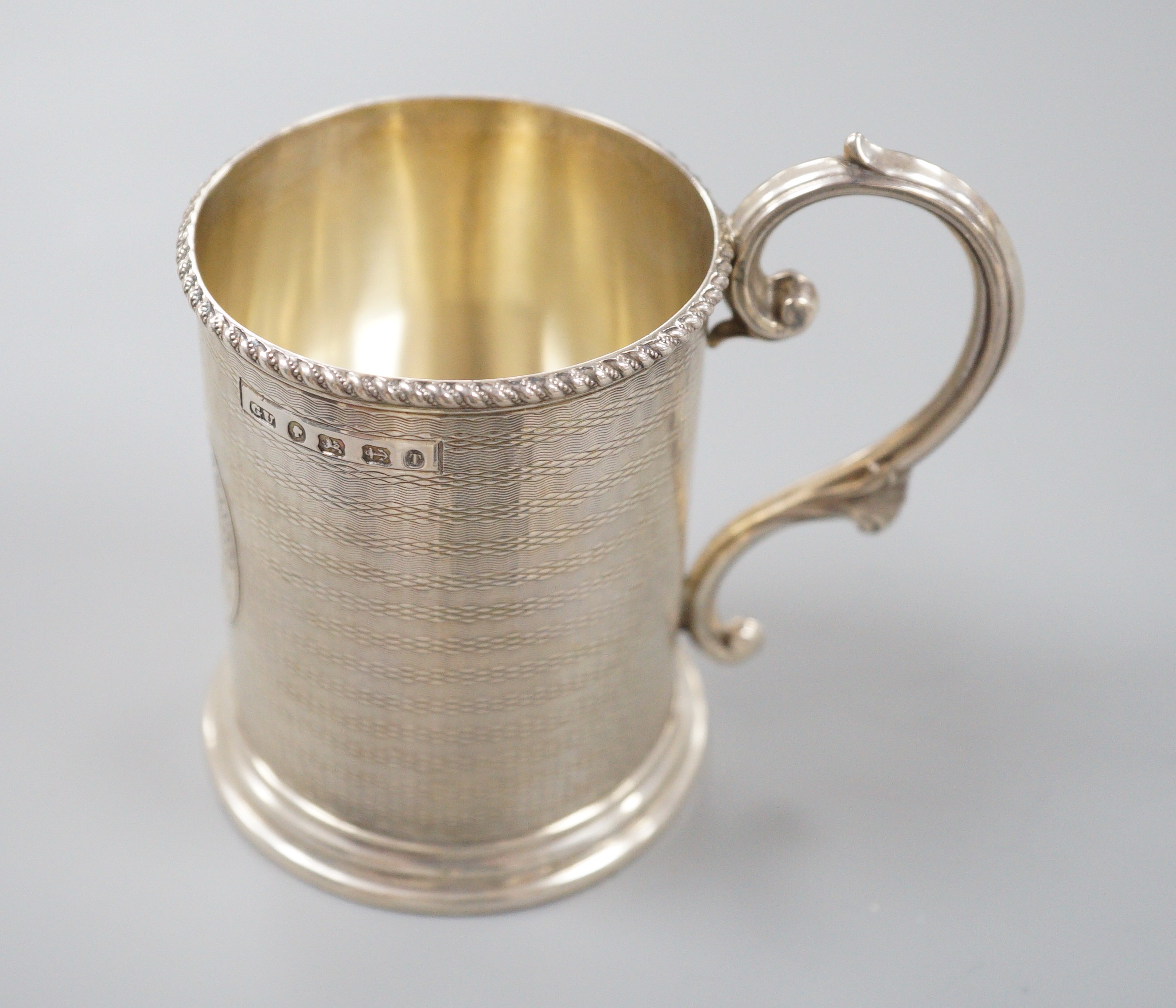A Victorian engine turned silver christening mug, with engraved inscription, George Unite, Birmingham, 1868, 86mm.